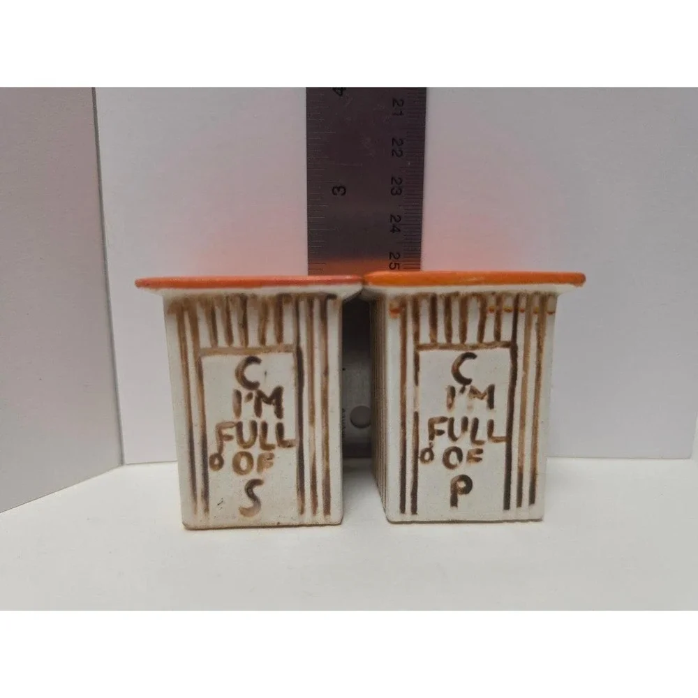 vintage, comical salt and pepper shakers feature an outhouse design with humorou